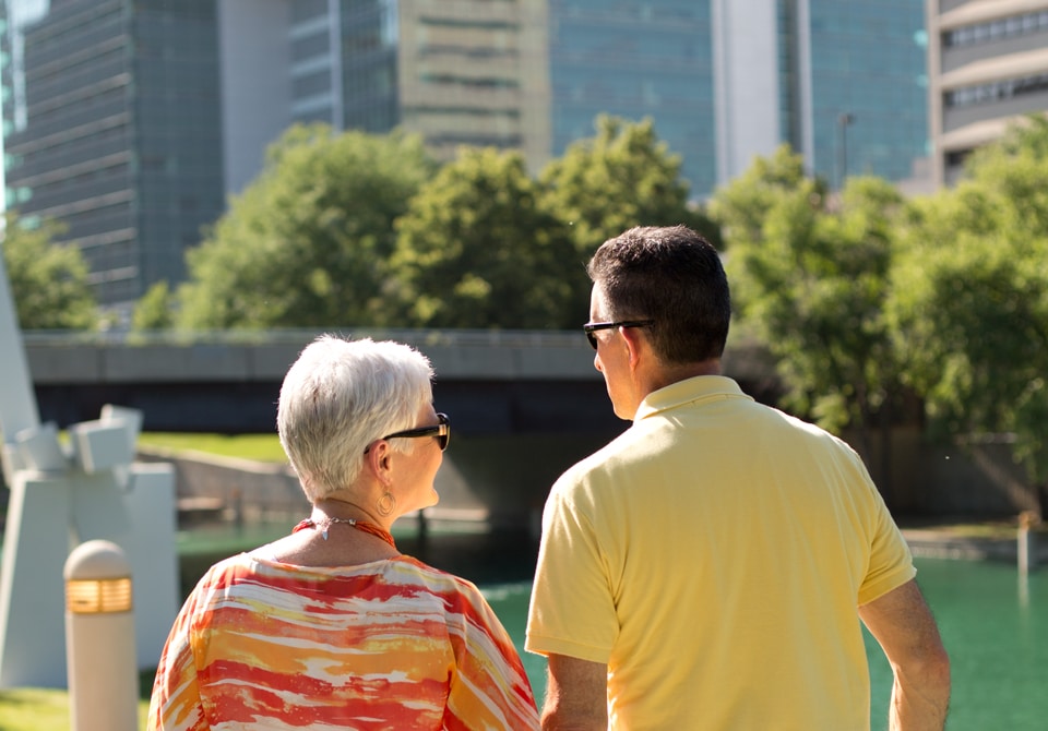 Photo of an older couple walking in a park