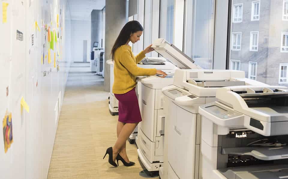 Photo of a business woman using a copying machine