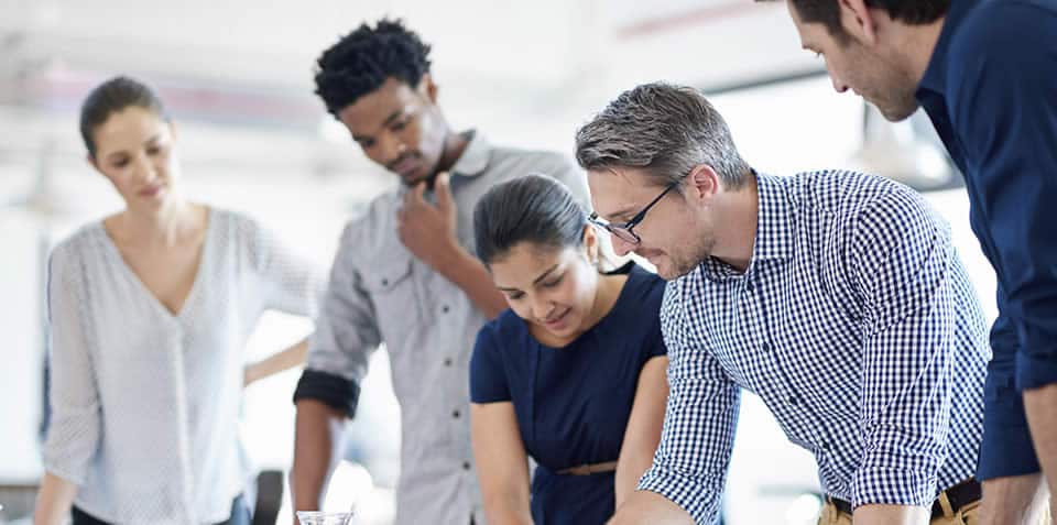 Photo of employees brainstorming with their manager